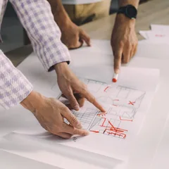 Two people marking up a garden plan together